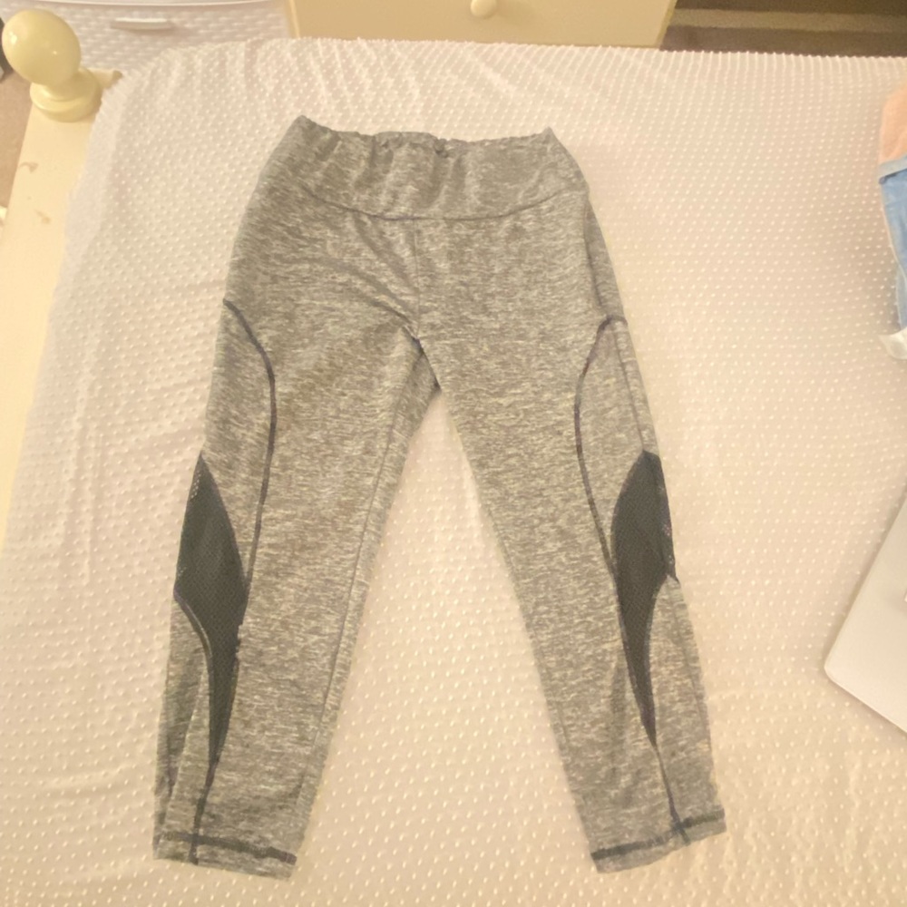 Grey workout leggings with black mesh on legs